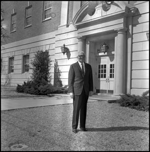 [Dean A. Witt Blair standing outside of the Education-Home Economics Building]