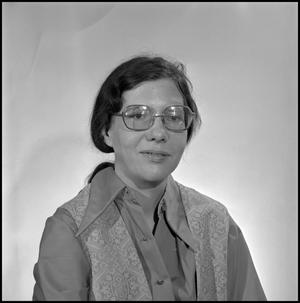 [Edra Bogle seated for a portrait, with glasses]