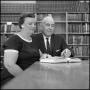 Photograph: [Dr. and Mrs. Blackburn seated at a library table 2]