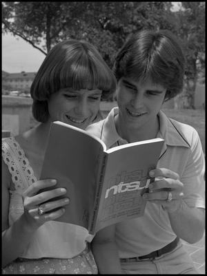 [Rosemary and Max Bruchwald reading a course catalog]
