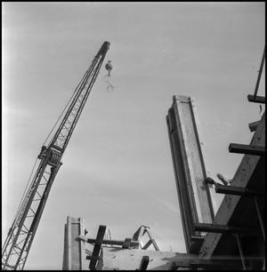 [Crane and building under construction]