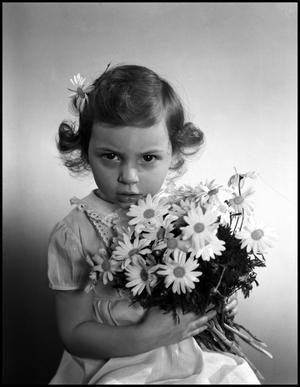 Primary view of object titled '[A little holding a bouquet of daisies, 7]'.