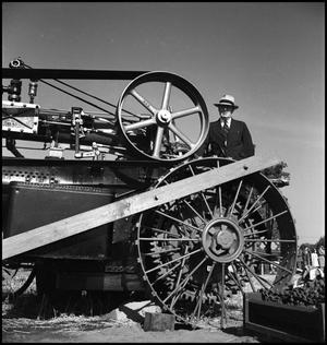 Primary view of object titled '[Man standing at an engine]'.