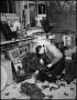 Photograph: [Man disassembling old telephones]