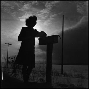[Woman reading her mail]