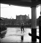 Photograph: [Man standing in the rain]