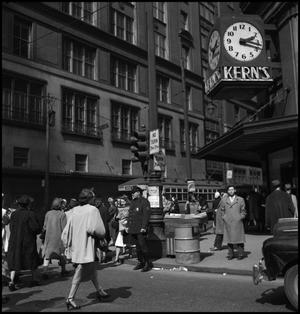[Pedestrians crossing the street by Kern's department store]