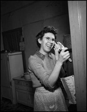 [Woman laughing on the phone in the kitchen, 2]