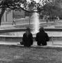 Photograph: [Two people sitting in front of Jody's Fountain]