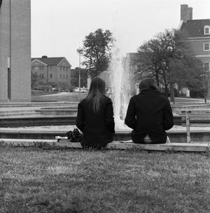 [Two people sitting in front of Jody's Fountain, 4]