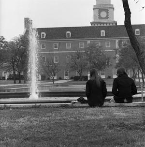 [Two people sitting in front of Jody's Fountain, 3]
