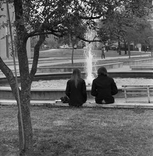[Two people sitting in front of Jody's Fountain, 2]