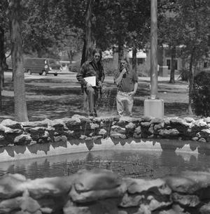 [Two UNT students looking at a fountain]