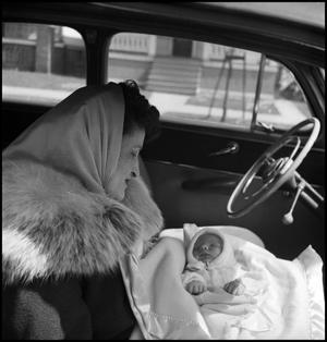 [Bernice holding baby Junebug in an automobile]
