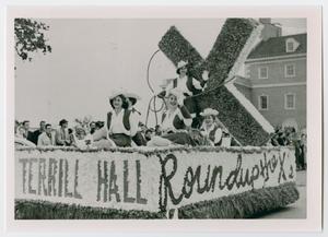 [Homecoming Parade float passing in front of the Administration Building]