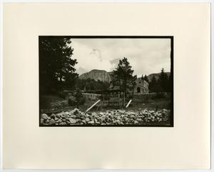 [Photograph of single building by the mountains]