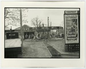 [Print photograph of a carousel and movie poster]