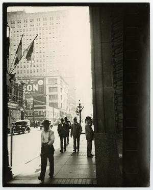 [Photograph of men walking on 7th & Main]