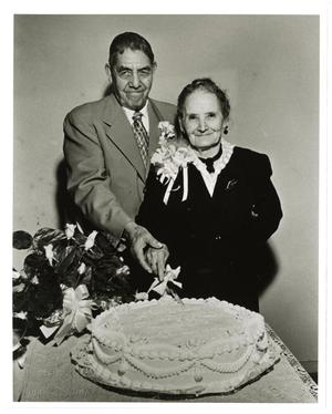 [Macario and Adelaida Cuellar cutting a cake]