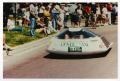 Photograph: [Crowds watch the solar car drive by]