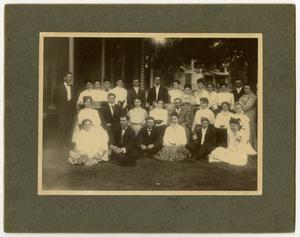 [Men and women on the lawn of a boarding house]