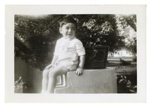 Primary view of object titled '[Bob Cuellar sitting on ledge]'.