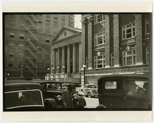 [Photograph of large buildings on a city street]