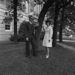 [Two individuals posing with a tree, 4]