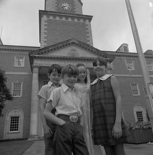 [Four children in front of the Hurley Administration building]