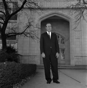 [Dr. Ernest Clifton standing in front of the Auditorium English Building]