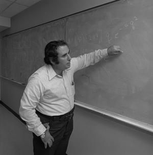 [Man standing in front of a blackboard, 4]