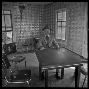 [Man sitting in a domino parlor]