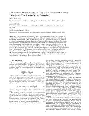 Laboratory experiments on dispersive transport across interfaces: The role of flow direction