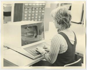 [A woman using the computer in the Library]