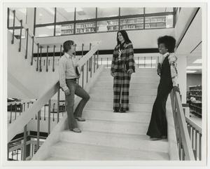 [Three students standing on A. M. Willis, Jr. Library stairs]
