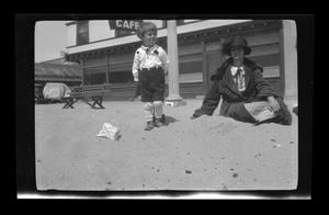 [Charles and Irene Williams on a beach in front of a cafe]
