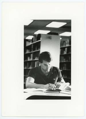 [Male student studying in North Texas State University library]
