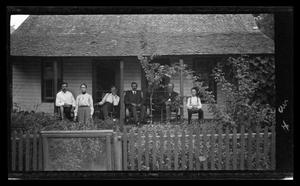 [An unidentified family on their front porch]
