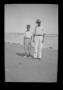 Primary view of [Byrd Williams Jr. on the beach with his son John]