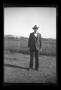 Photograph: [Byrd Williams Jr. standing in a backyard]