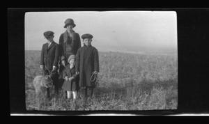 [The Williams family standing in a field]