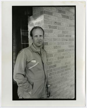 [Photograph of man in jumpsuit]