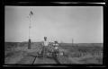 Photograph: [Two men on a rail cart]