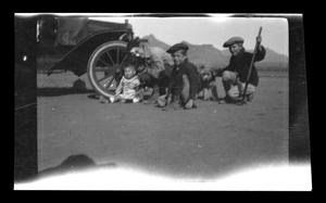 [Irene Williams posing with her children in the desert]