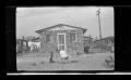 Photograph: [Children playing in front of a house]