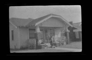 Primary view of object titled '[The Williams family standing on their front porch]'.