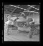 Photograph: [Bell employees working on the fuselage of an XH-40]