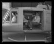 Photograph: [Service men sitting in the YH-40]