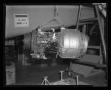 Photograph: [The Lycoming turbine engine being hoisted to the top of XH-40 #1]