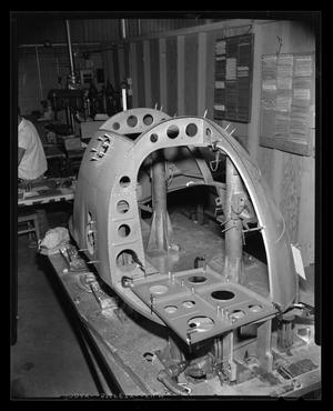 [Nose assembly of the XH-40 in progress, side view]